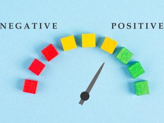 arrow pointing to 'positive' on a scale from red negative to yellow neutral to green positive